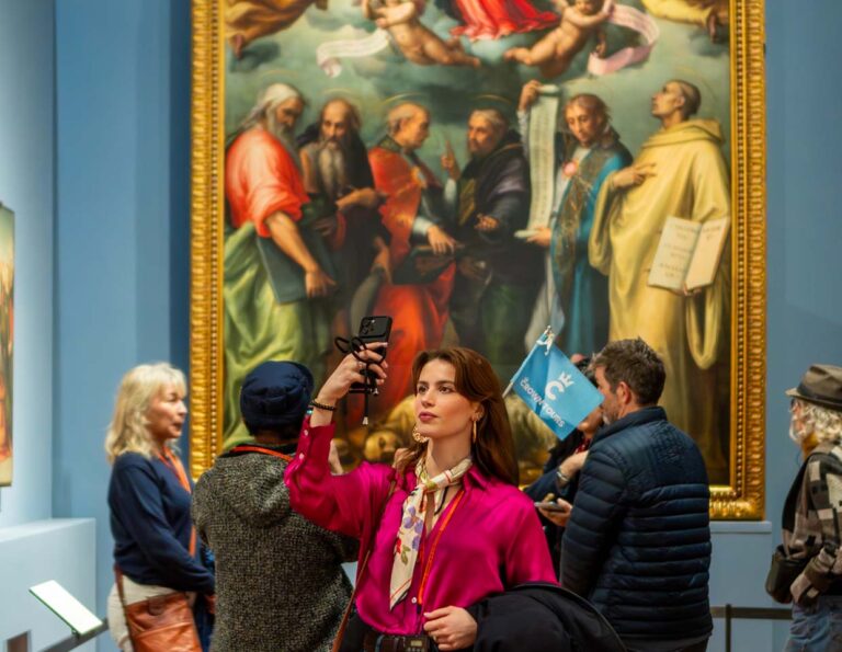 A visitor photographing the famous artwork on display at Accademia Gallery