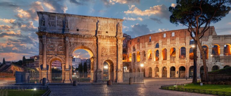 The Arch of Constantine and the Colosseum illuminated at twilight