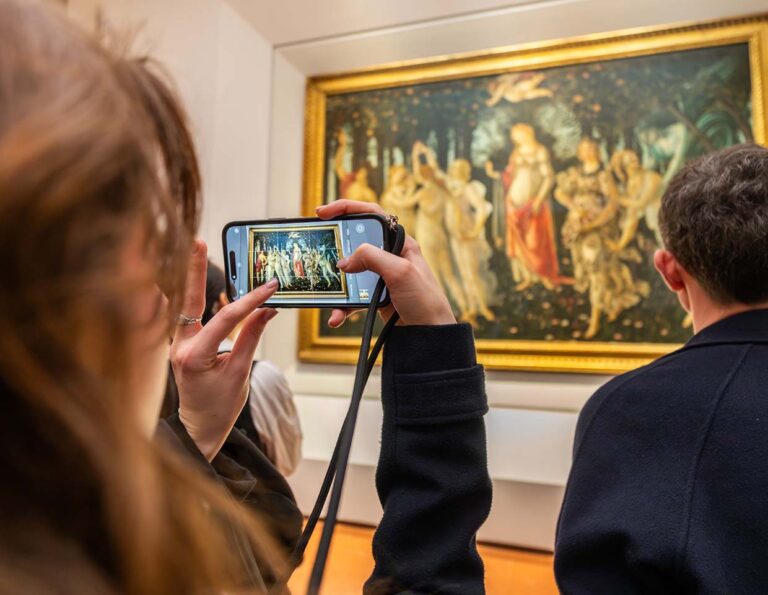 Girl looking at the painting of birth of venus in Uffizi Gallery